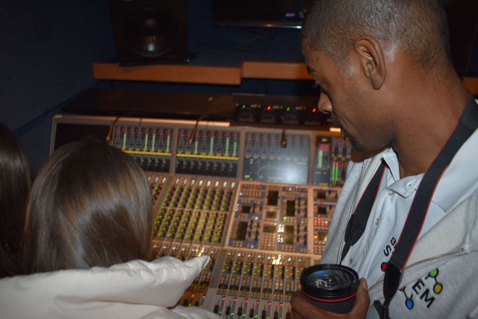 Two people in front of mixing desk