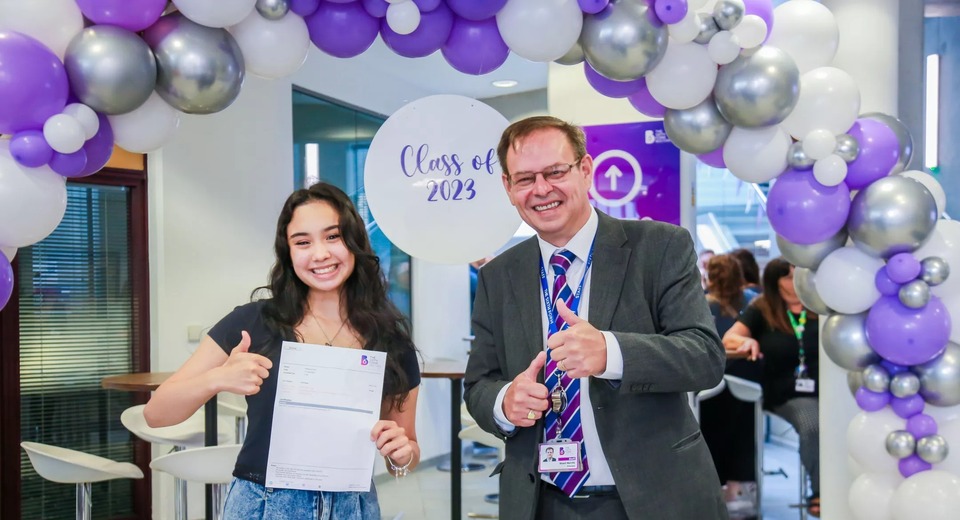 Photograph showing Principal Stuart Merrills celebrating results with a student
