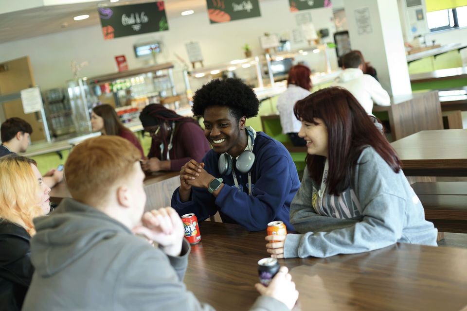 Image of three students socialising