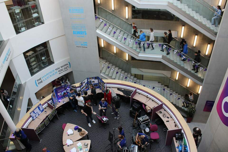 Photo of the inside of Bolton Sixth Form main entrance showing stairways and mezzanine areas from an elevated position
