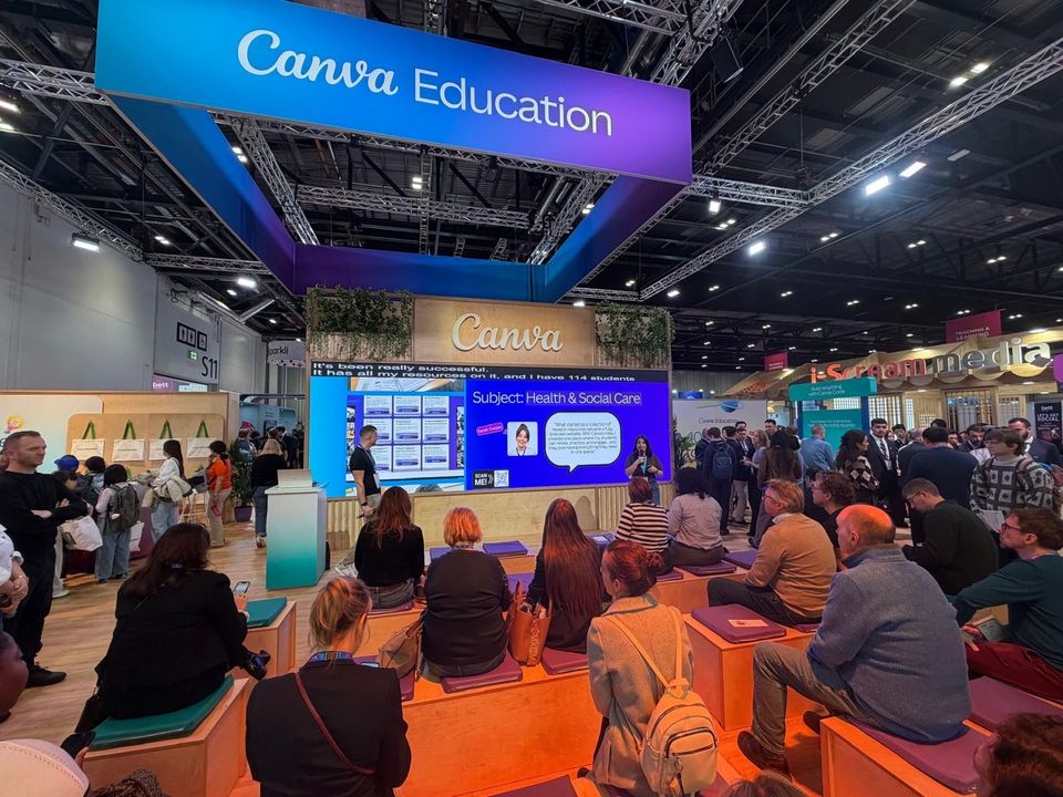 Image of Canva exhibit and visitors at conference