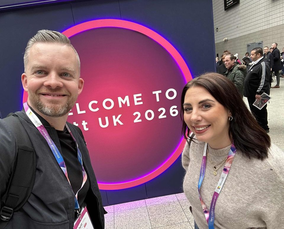 Image showing two members of staff in front of welcome screen