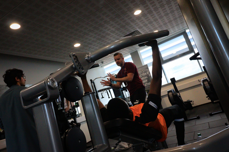 Student and staff in gym