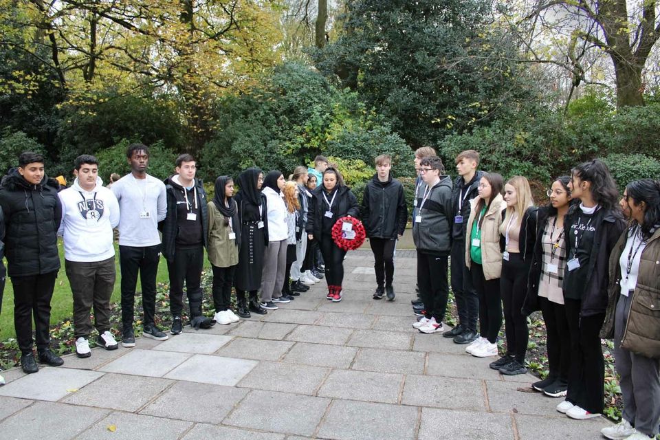 Students presenting poppy wreath