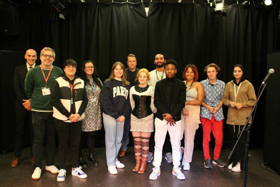 Group of students and staff at open mic sessiom