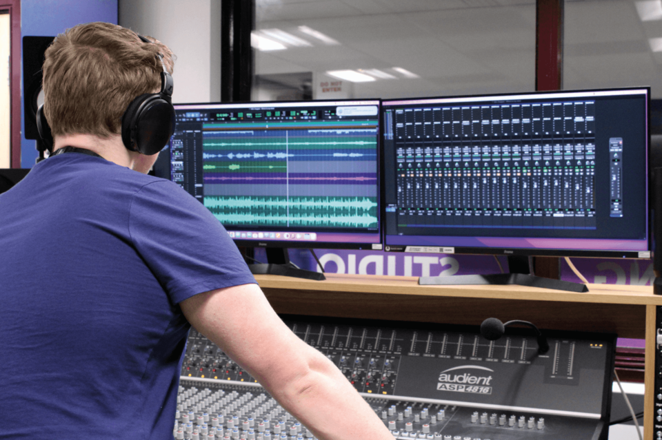 Image of student editing music using a recording studio