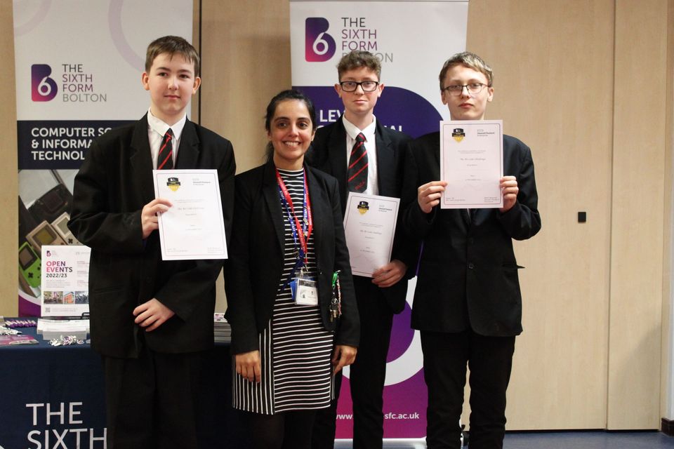 Group of school students and staff memberwith certificates