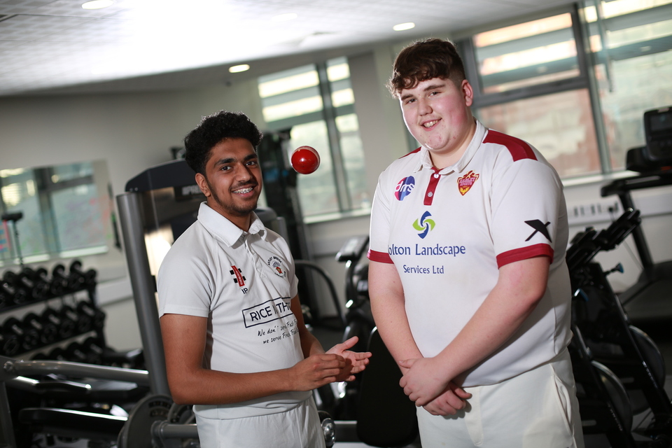 Image of two students in Cricket kit 